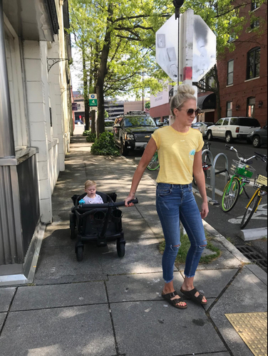 mom pulling kid in veer wagon