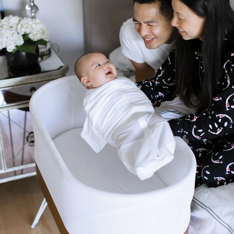 baby getting put into snoo